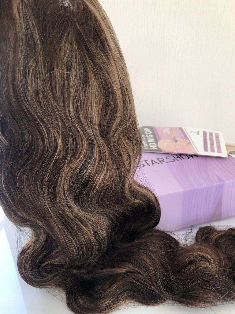 It looks beautiful right out of the packaging. The curls and length are real! ! You can definitely style this wig anyway you want! Hopefully, this will make ladies feel at ease when it comes to making honest reviews!